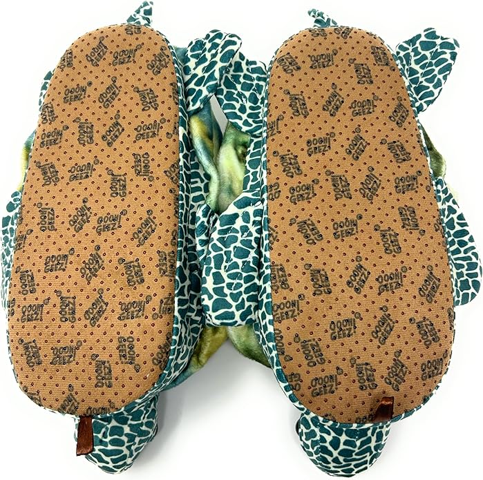 Plush turtle slipper with green and blue pattern on a white background